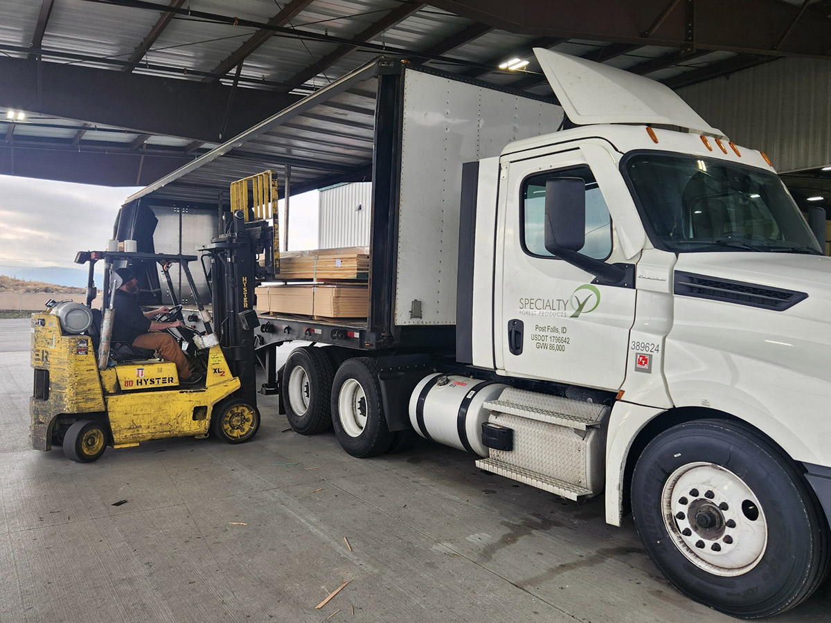 image of a Specialty Forest Product delivery truck unloading lumber